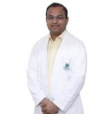 "Dr. Kewal Gangrade, Orthopedic Surgeon at Bansal Hospital, Bhopal, wearing a white lab coat."